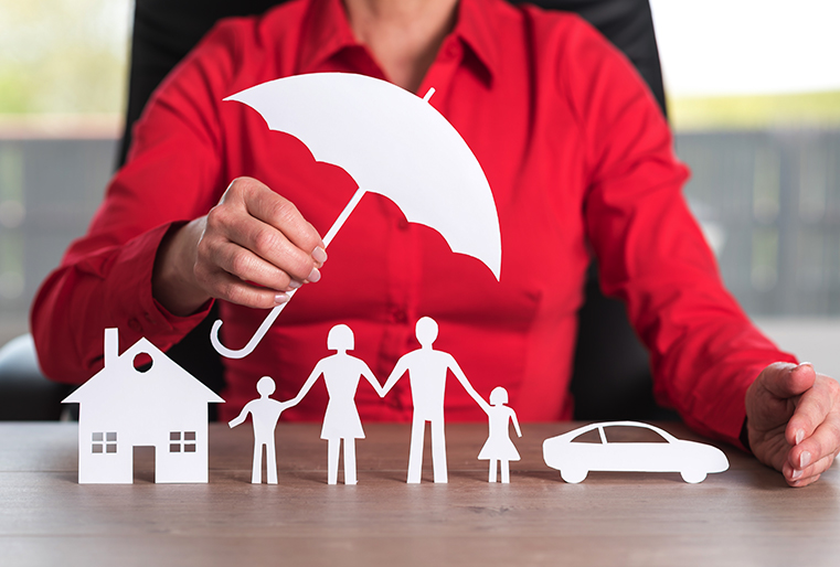 Paper cut outs of home and auto insurance